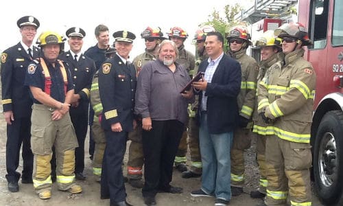 Don Fraser (centre) accepts a plaque honouring his contributions to extrication training for Brampton Fire and Emergency Services.